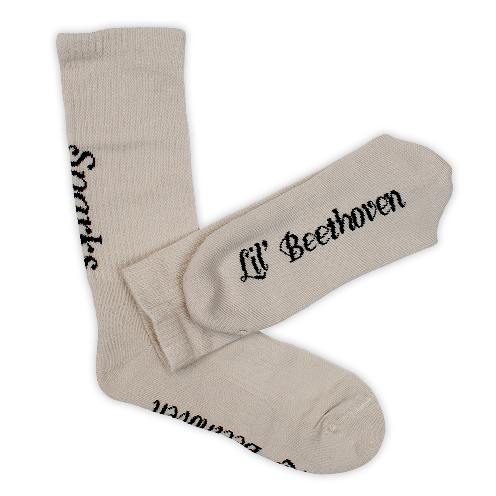 Pair of beige socks with ’Lil’ Beethoven’ printed on the side.
