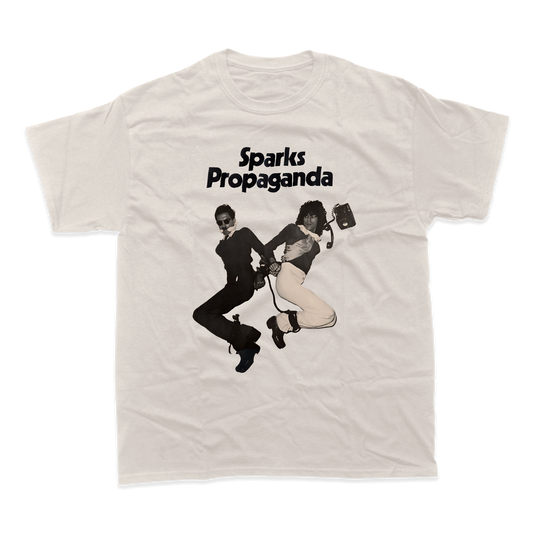 White t-shirt featuring a black and white graphic design and text reading ’Sparks Propaganda’.